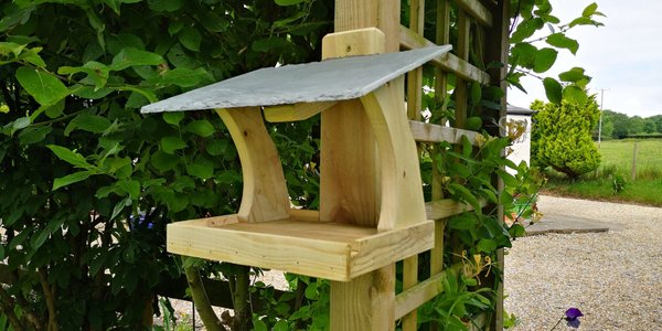Wall hung bird feeder with natural slate roof